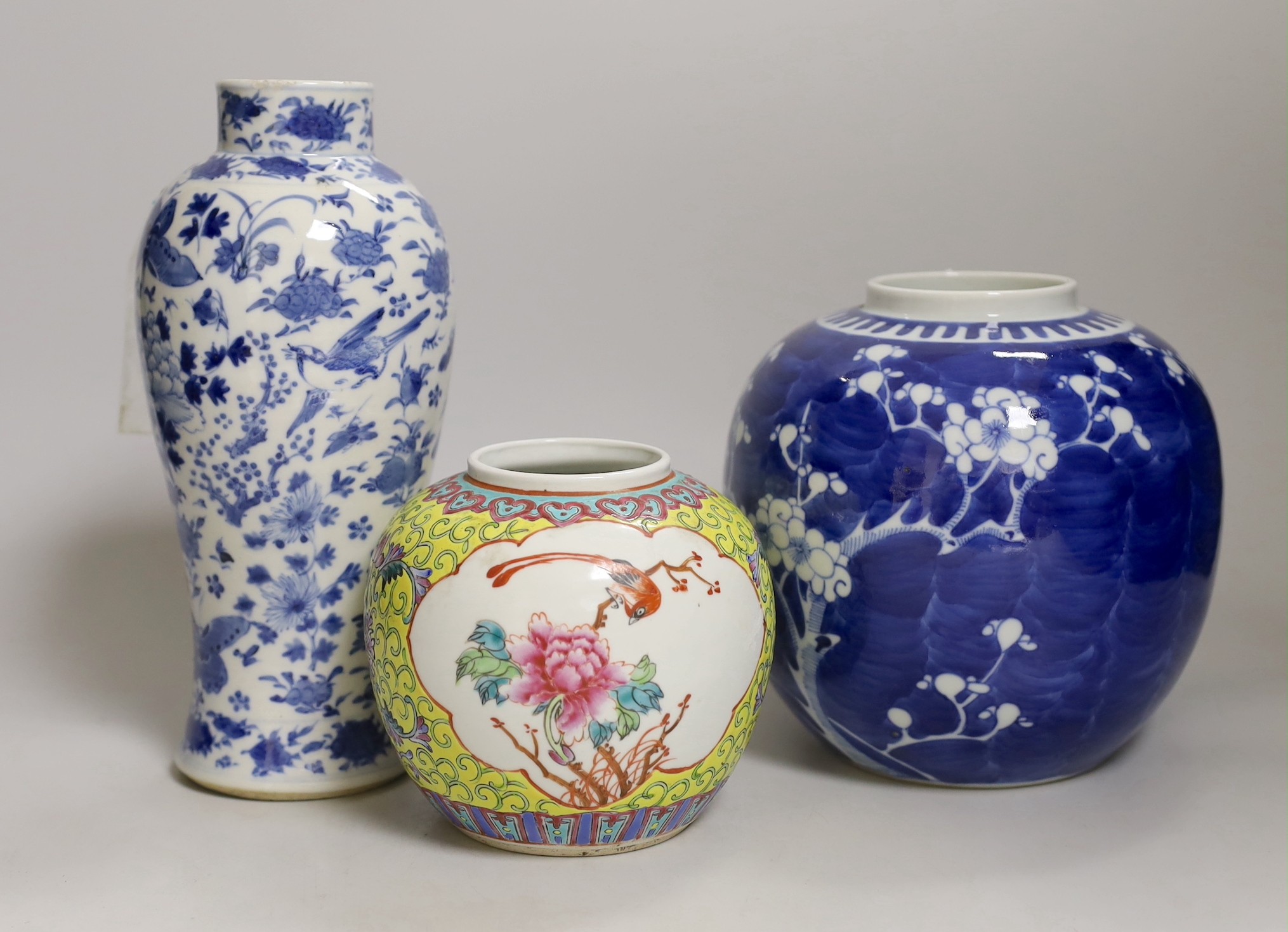 A 19th century Chinese blue and white ‘birds and flowers’ baluster vase, a blue and white jar and a famille rose jar